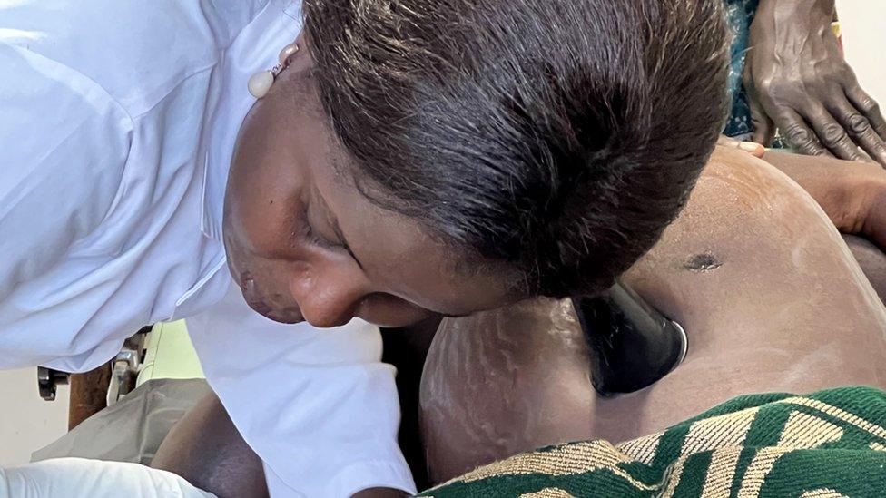 Doctor listening to a baby's heart beat