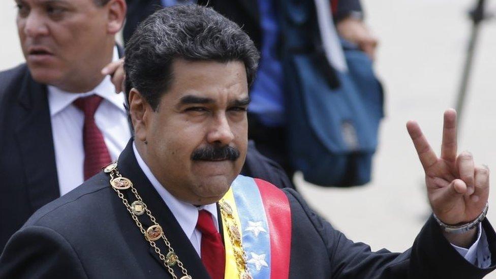 Venezuela's President Nicolas Maduro flashes a victory sign at supporters during a parade marking Venezuela's Independence Day in Caracas, Venezuela, Tuesday, July 5, 2016.