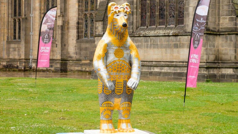 Bear Statue in front of a cathedral