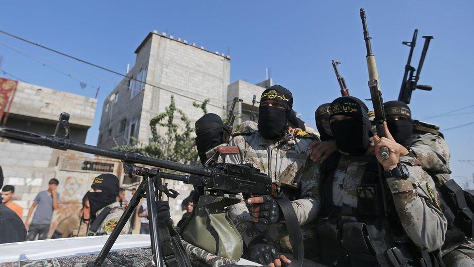 Palestinian Islamic Jihad militants ride in a pick-up truck during a funeral in southern Gaza (14 November 2019)