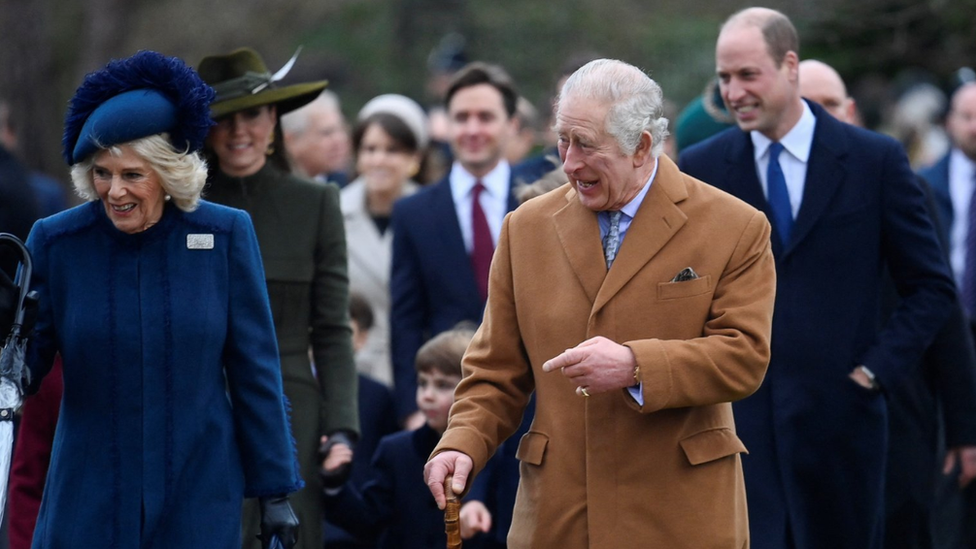 King Charles III walks along side the Queen Consort after attending the Royal Family's Christmas Day service in Sandringham