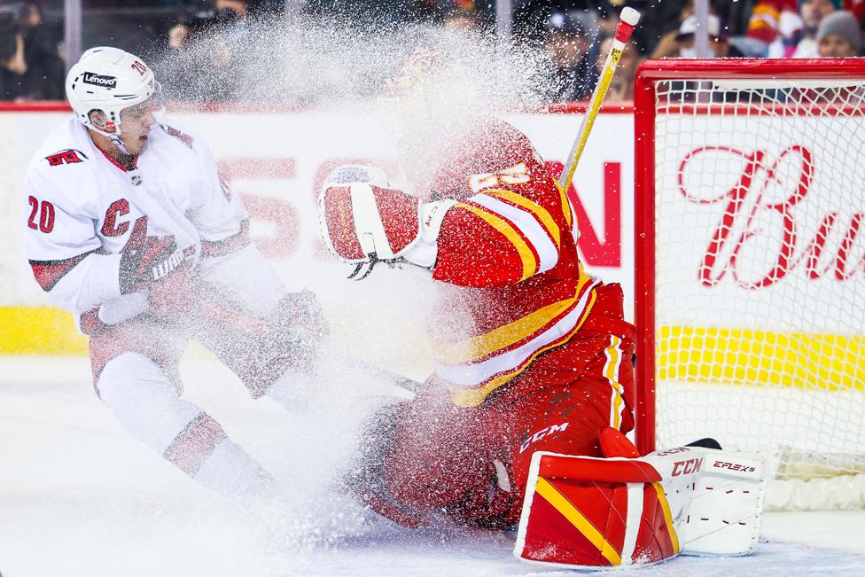 Carolina Hurricanes right wing Sebastian Aho scores a goal against Calgary Flames goaltender Jacob Markstrom during the overtime period at Scotiabank Saddledome, Calgary, Alberta, Canada.