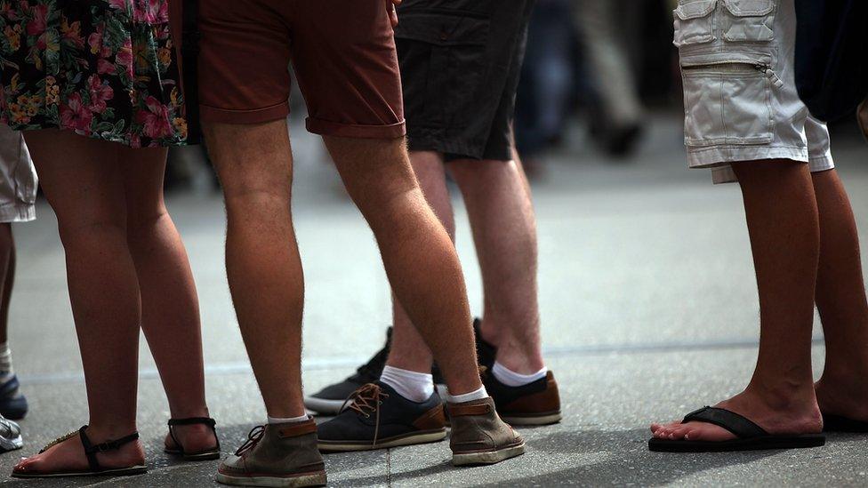 Men wearing shorts, viewed from the legs down