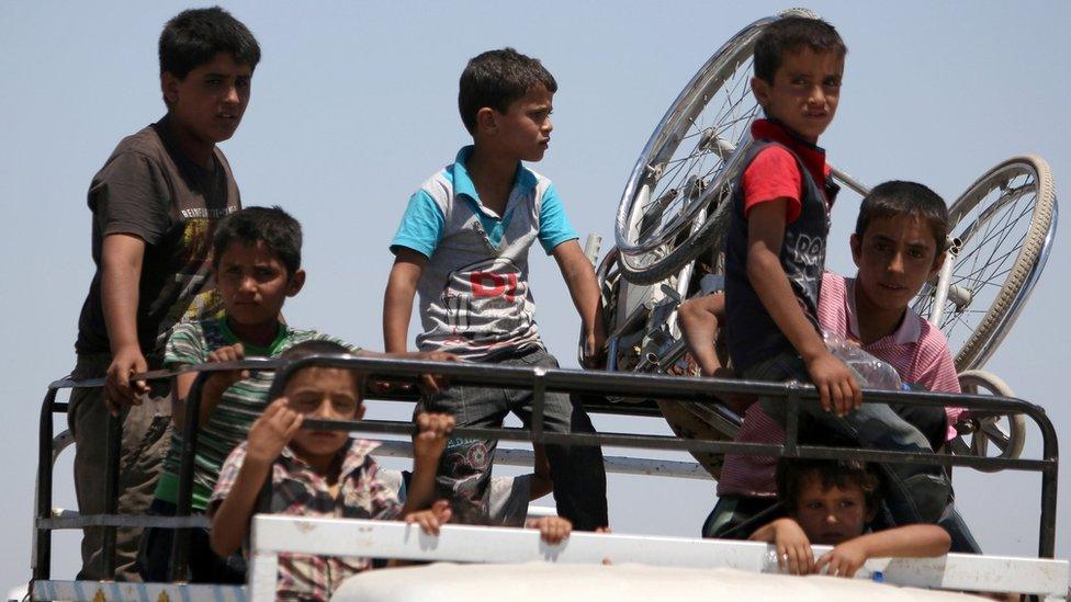 Boys on a pick-up truck flee southern Manbij after advance by Syria Democratic Forces fighters (1 July 2016)