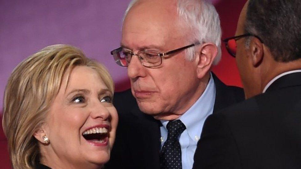 Democratic presidential candidates Hillary Clinton (left) and Bernie Sanders (right) confer during the NBC News -YouTube Democratic Candidates Debate (17 January 2016)