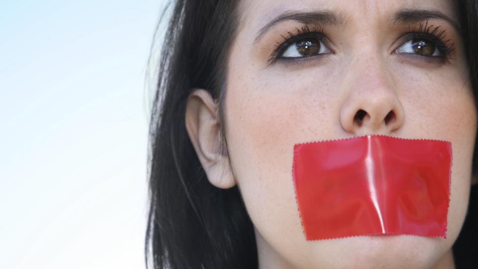 Woman with taped-up mouth