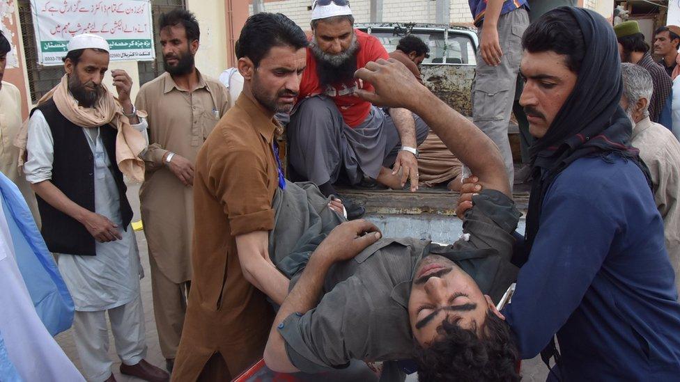 People carry a coal miner who was injured in a mine explosion to a hospital in Quetta, Pakistan, 5 May 2018.