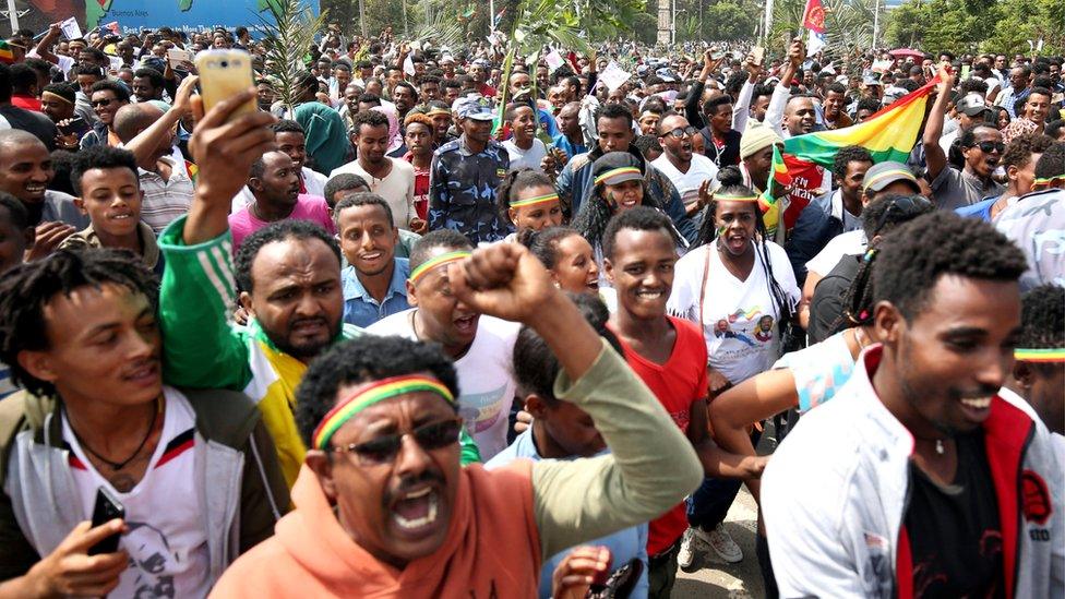 People celebrate during the welcoming ceremony of Eritrea's President Isaias Afwerki arriving for a three-day visit, at the Bole international airport in Addis Ababa, 14 July 2018