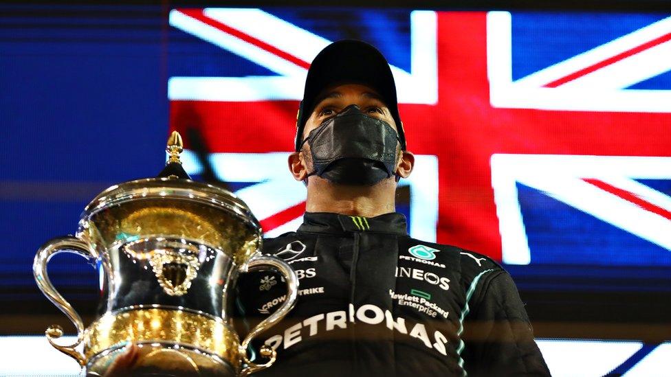 Race winner Lewis Hamilton celebrates on the podium after during the F1 Grand Prix of Bahrain