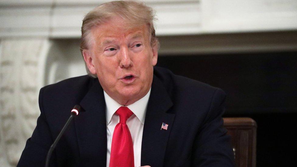 President Donald Trump is seen sitting in the White House in this photo