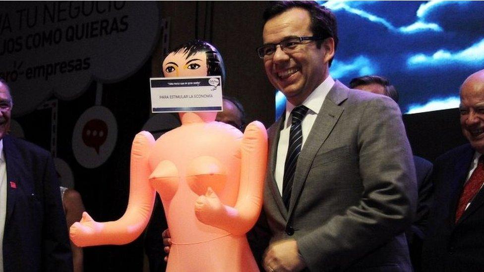 Chile's economy minister Luis Cespedes holds up an inflatable doll during an event of the exporters' association Asexma in Santiago, Chile, December 13, 2016.