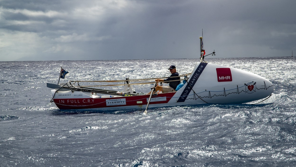 Andrew Osborne rowing on his boat