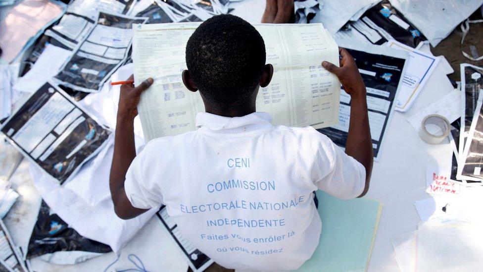 Man looking at voting material