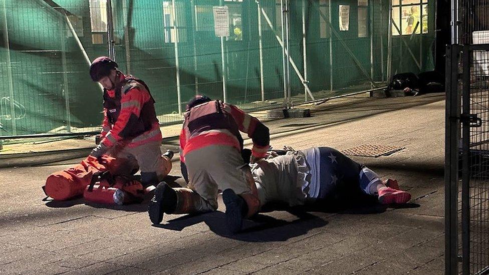 Emergency services attending to casualty in training exercise