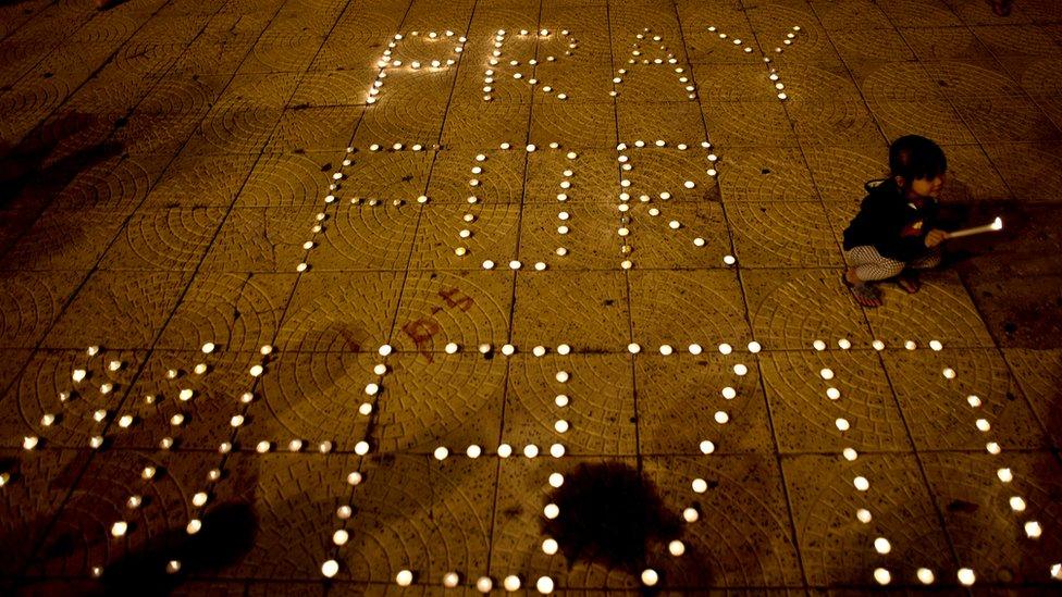 A Malaysian ethnic Chinese girl lights candles during a vigil for missing Malaysia Airlines passengers at the Independence Square in Kuala Lumpur on March 10, 2014.