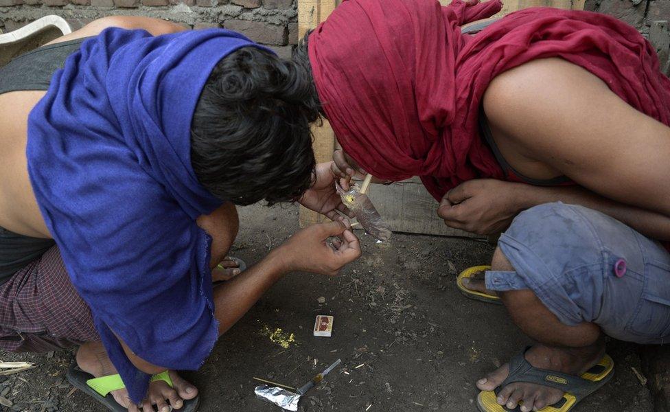 Indian youth inhale drugs on the outskirts of Jalandhar in the north western Punjab province on June 15, 2016