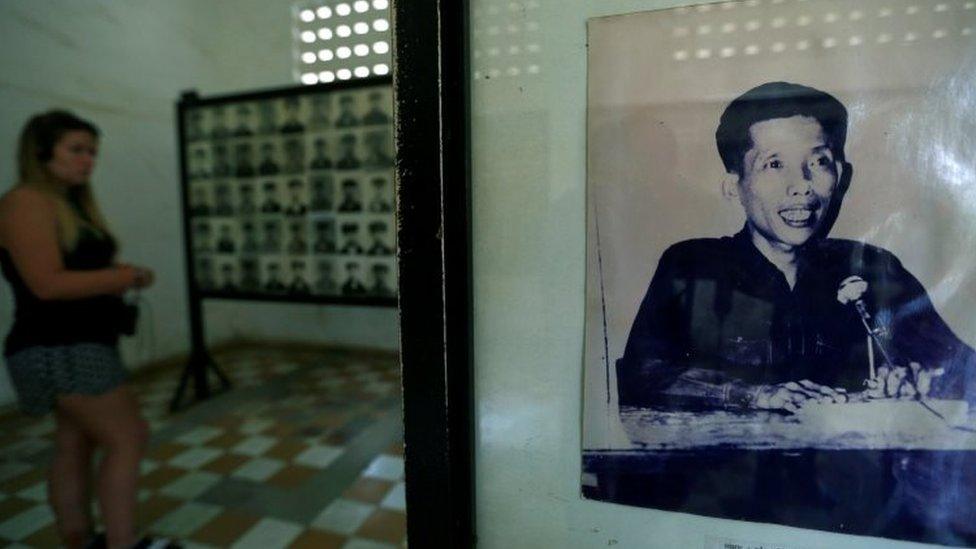 A visitor walks pass a picture of Kaing Guek Eav, also known as Comrade Duch, at the Genocide Museum in Phnom Penh (09 June 2016)