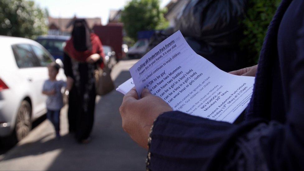 Person holding leaflets