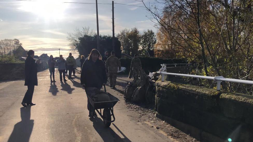 Locals with sandbags