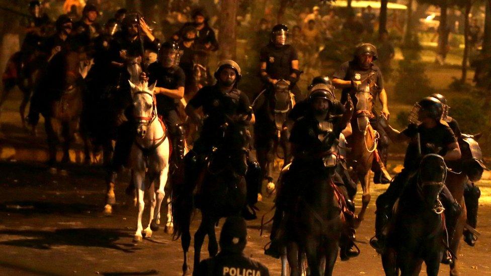 Police on horseback are seen during a demonstration against a possible change in law to allow for presidential re-election in front of the Congress building in Asuncion, Paraguay, March 31, 2017.