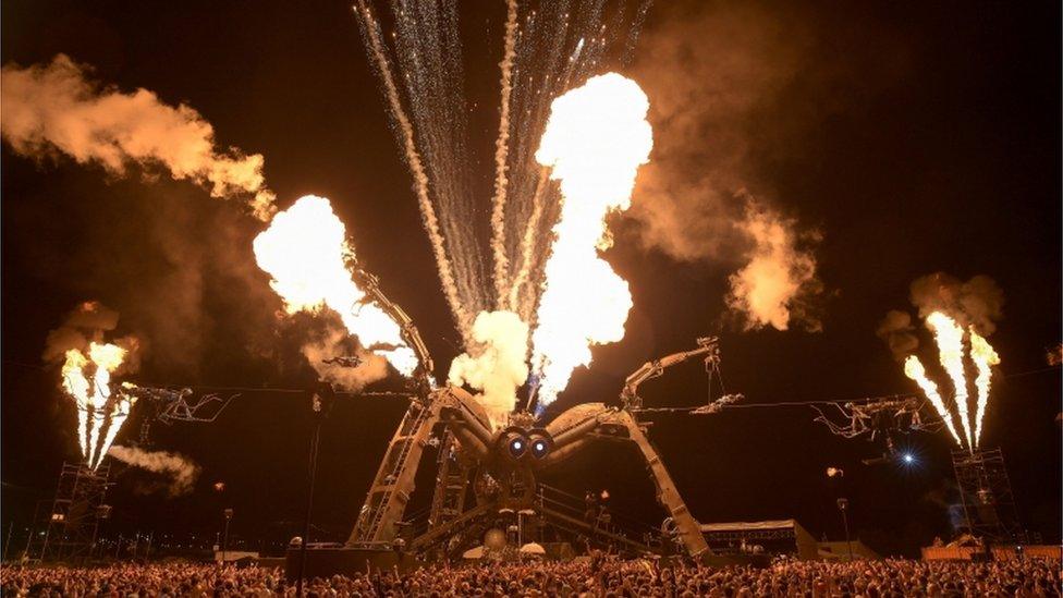 People dance beneath the giant spider at Arcadia, at the Glastonbury Festival at Worthy Farm in Pilton (early Sat am 24/6/17)