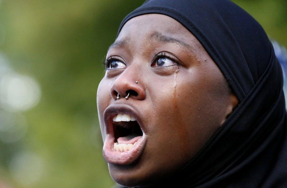 A woman protests the shooting death of Alton Sterling near the headquarters of the Baton Rouge Police Department in Baton Rouge, Louisiana, U.S. July 9, 2016