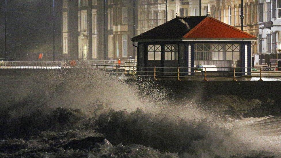 Waves crash against the sea wall in Aberystwyth in west Wales as Storm Eleanor hits the UK causing power cuts and road disruption