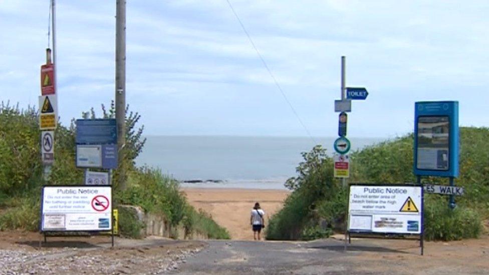 Path to beach with warning signs