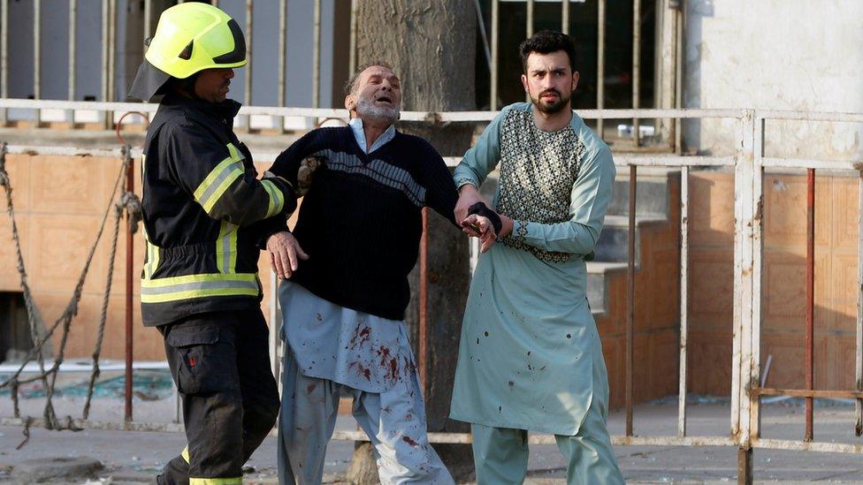 A man reacts after hearing his son was killed in a Kabul bombing, 27 January 2018