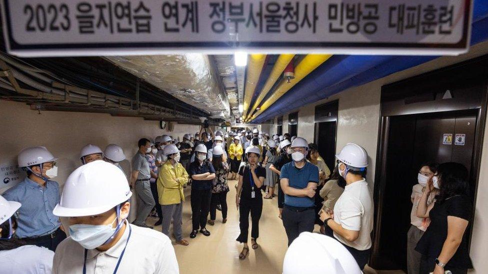 South Korean government official take shelter during a nationwide air raid drill