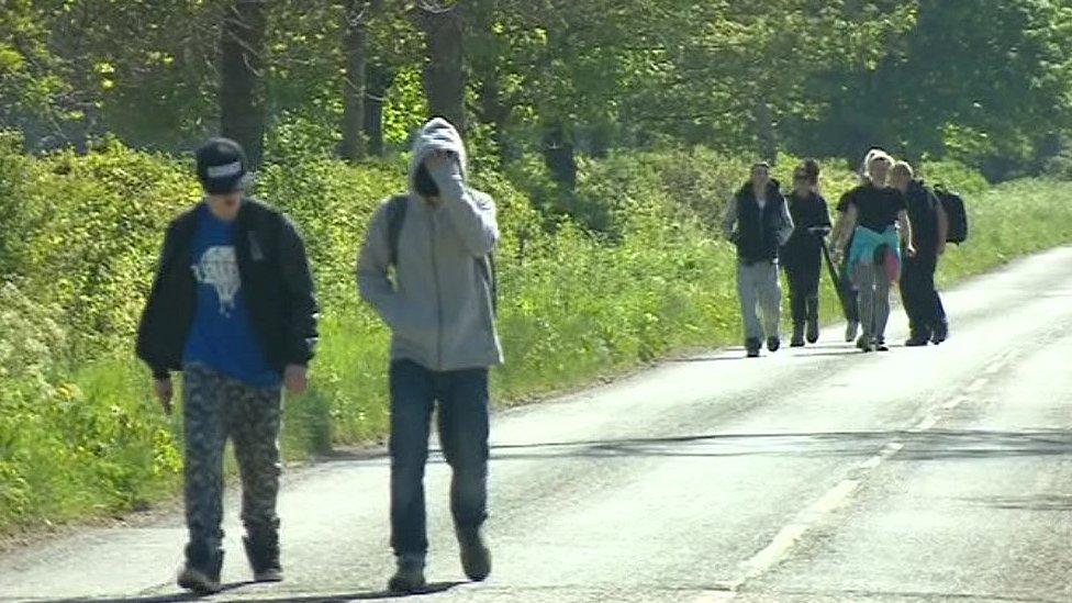 Revellers leaving illegal rave outside Frome, Somerset