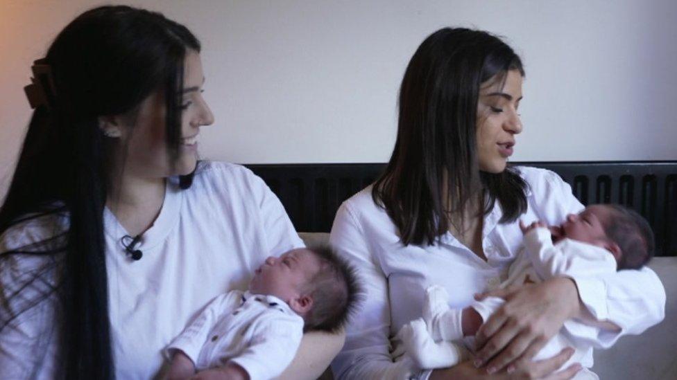 Bethany (left) holds her baby Apsey-Lee and smiles as she watches Zara rock baby Cassius.