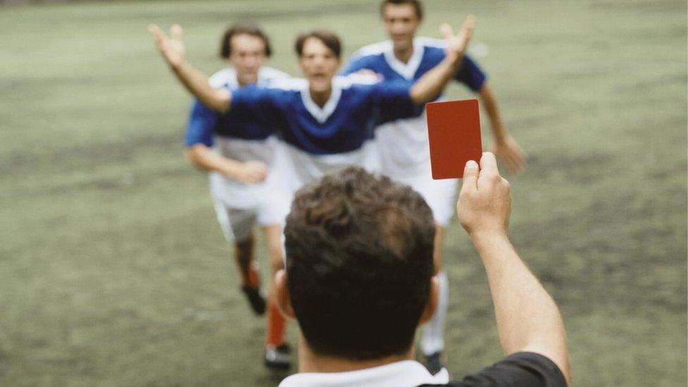 Referee showing red card