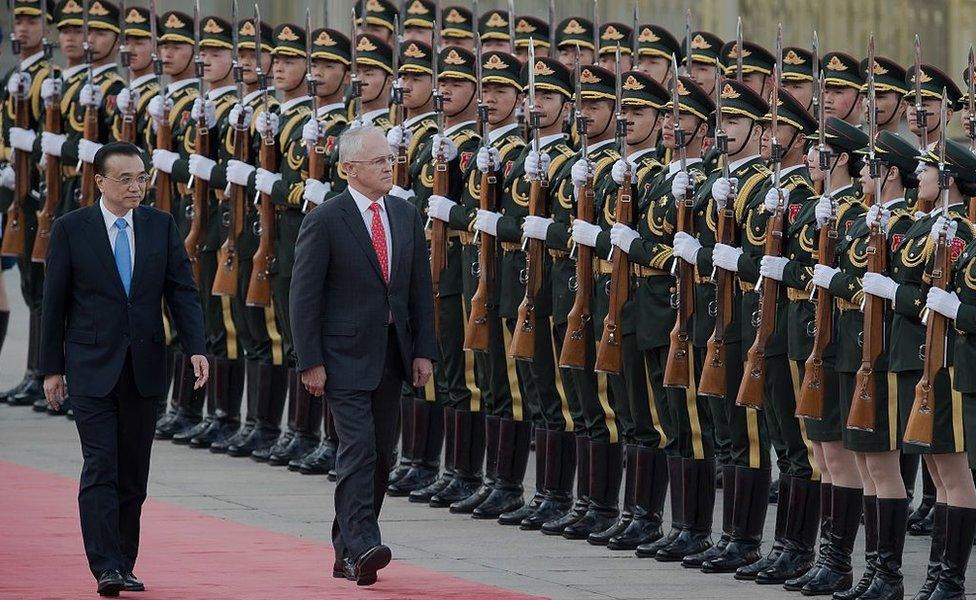 China's Premier Li Keqiang escorts Malcolm Turnbull past a line of Chinese military guards at an official welcome ceremony in Beijing in 2016