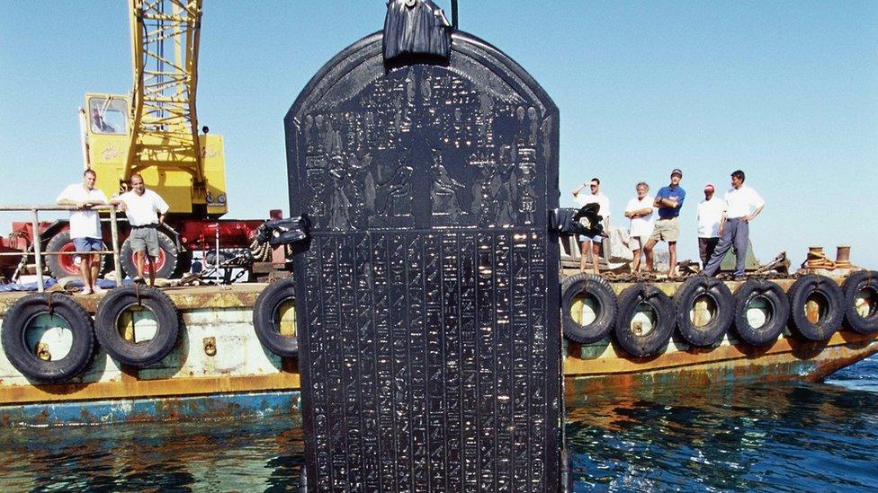 A stone tablet, called a stele, being hoisted from the water in a remarkable state of preservation. The treasure has gone on display at the British Museum in London.