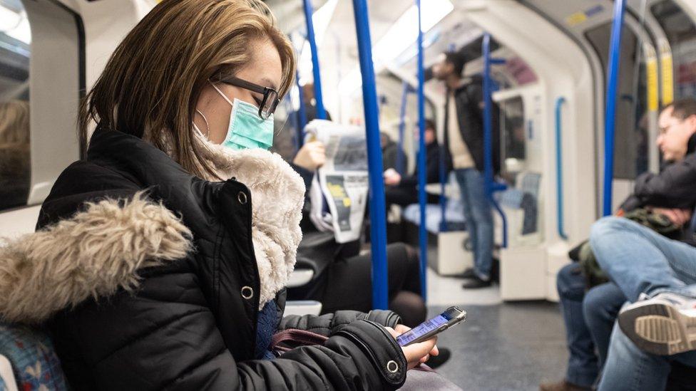 Woman wearing a mask on the London Underground