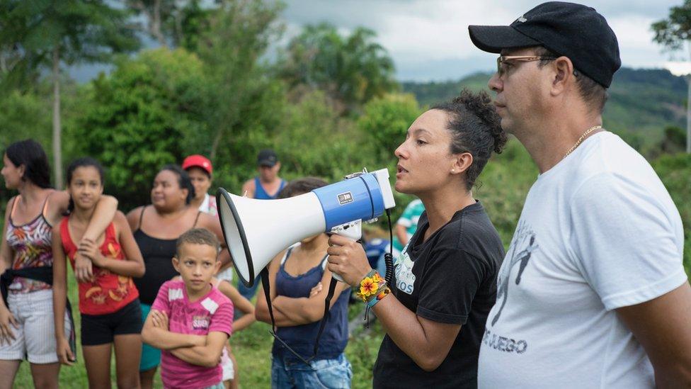 Isabel Zuleta addresses people with a megaphone