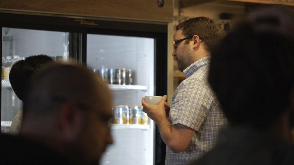 Cal Henderson holds a cup of coffee