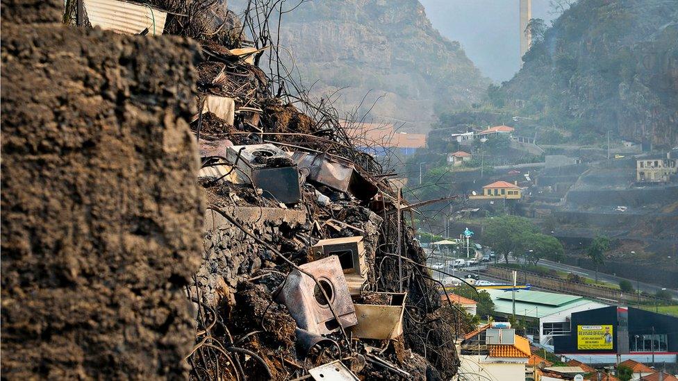 Charred debris from burned houses are pictured on the slopes of Campo da Barca, Funchal, Madeira island on 10 August 2016