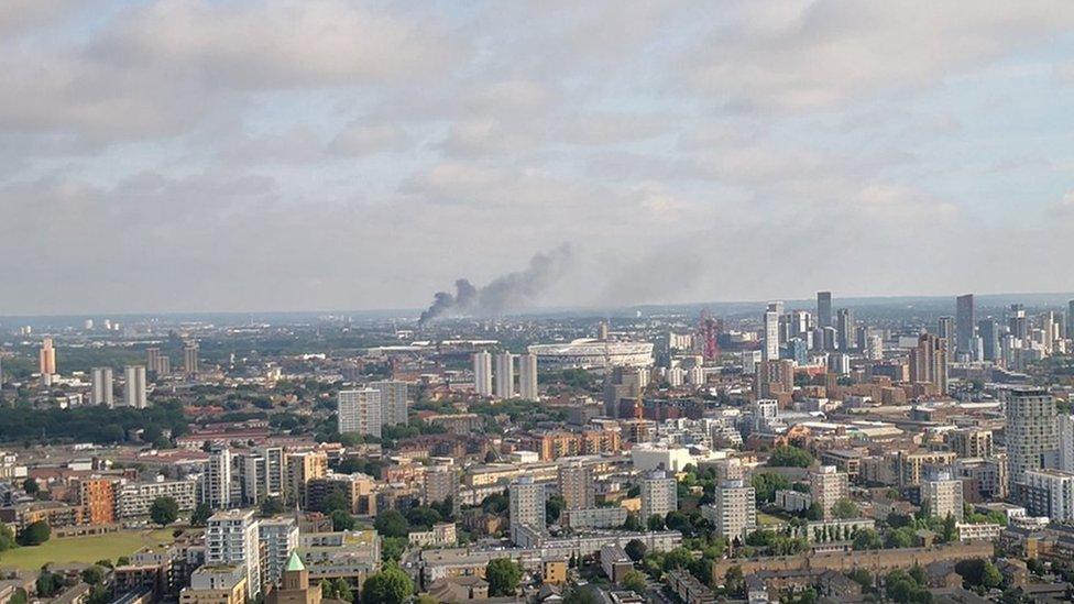 View from Canary Wharf of smoke billowing from the Mall