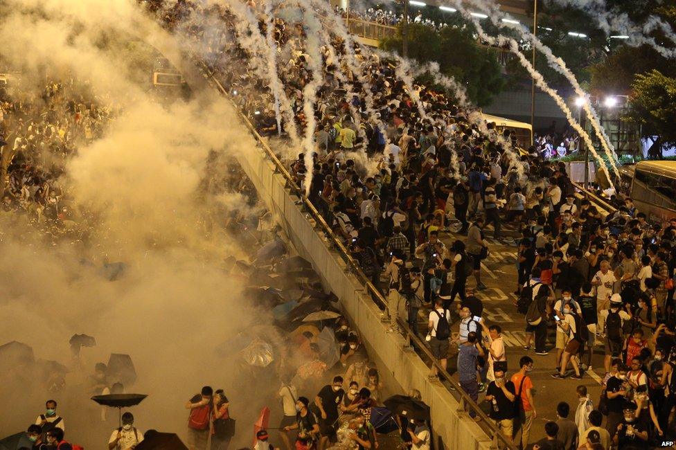 Police fire tear gas upon pro-democracy demonstrators near the Hong Kong government headquarters on 28 September 2014.