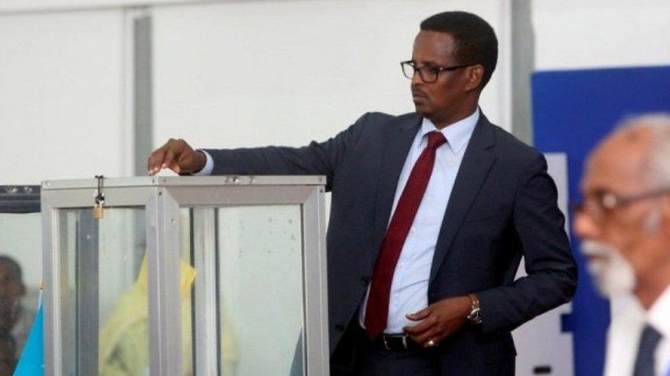 A Somali lawmaker casts his ballot during the presidential vote at the airport in Somalia"s capital Mogadishu February 8, 2017.