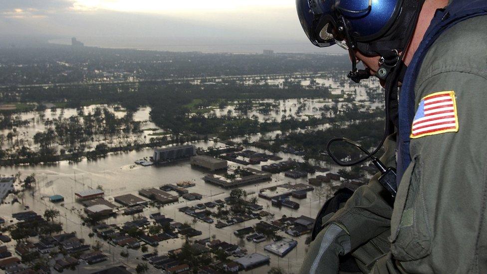 US personnel looks out over new orleans buried in water