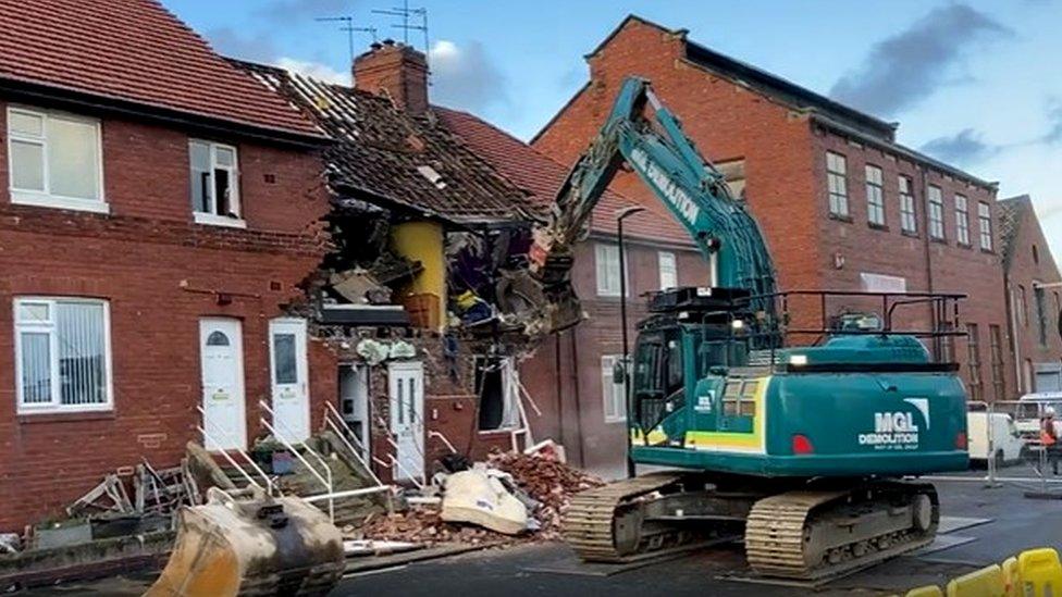 Part of the building being pulled down