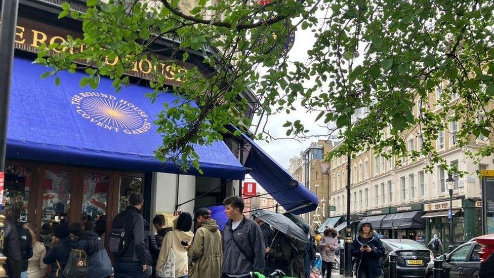 People peered through a pub's windows in central London to watch the Coronation