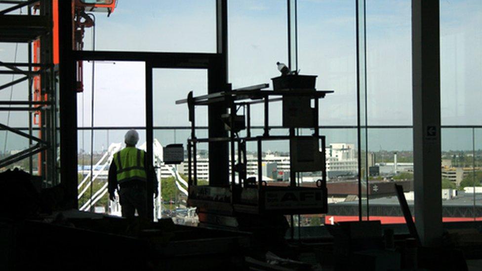 Builder looking through the window