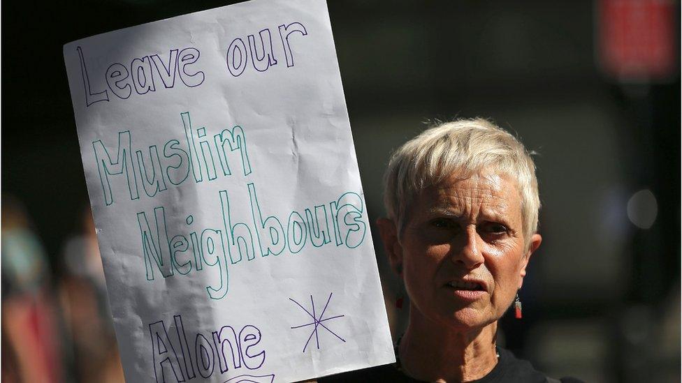 Woman holding sign of support