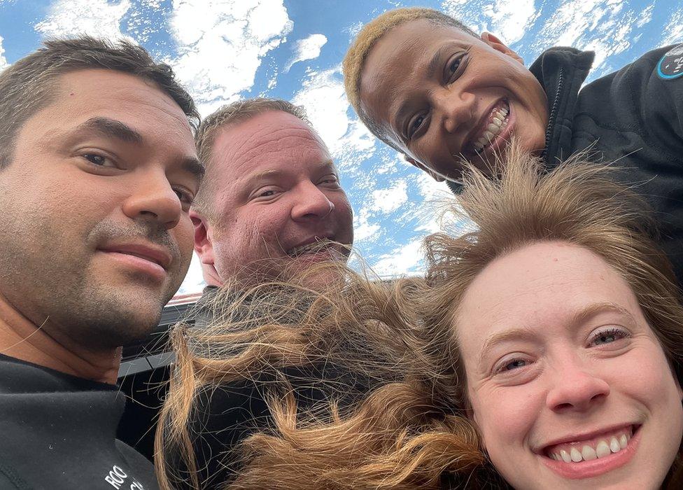 Jared Isaacman, Chris Sembroski, Sian Proctor, and Hayley Arceneaux pictured with Earth in the background