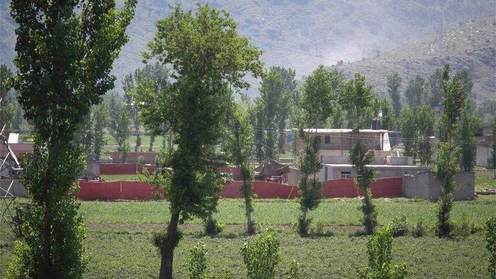 Surrounded in red fabric, a compound is seen where locals reported a firefight took place overnight in Abbotabad, located in Pakistan"s Khyber Pakhtunkhwa province on May 2, 2011.