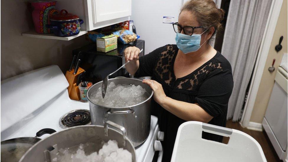 A woman boils snow for the water